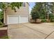 A two car garage and drive offer plenty of parking at 205 Devon Downs Pl, Alpharetta, GA 30005