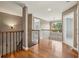 Upstairs hallway with wood floors and beautiful metal railing overlooking stairs, next to bedroom entrance at 205 Devon Downs Pl, Alpharetta, GA 30005