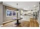 Eat-in kitchen with hardwood floors, granite countertops, stainless appliances, and white cabinets at 205 Devon Downs Pl, Alpharetta, GA 30005
