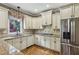 Kitchen featuring stainless steel appliances, granite countertops, white cabinets, and hardwood floors at 205 Devon Downs Pl, Alpharetta, GA 30005