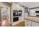 Kitchen features built-in oven and microwave, granite countertops and hardwood floors at 205 Devon Downs Pl, Alpharetta, GA 30005