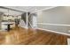 Open concept living room showcasing hardwood floors, staircase, and open view to the kitchen at 205 Devon Downs Pl, Alpharetta, GA 30005