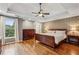 Bedroom features a trey ceiling, decorative wallpaper, ceiling fan, hardwood floors, and large windows at 205 Devon Downs Pl, Alpharetta, GA 30005