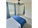 Well-lit bedroom with a view of neighborhood, fan, and blue and gray accents at 283 Wells Cir, Canton, GA 30114