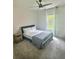 Neutral bedroom with a ceiling fan, a queen bed, and light streaming through the window at 283 Wells Cir, Canton, GA 30114