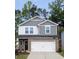 Charming two-story home with a stone-accented facade, a well-manicured lawn, and an attached two-car garage at 283 Wells Cir, Canton, GA 30114
