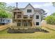 Backyard with a view of the house with a covered porch, a patio, and a wooden fence at 3006 Skyland Ne Dr, Brookhaven, GA 30319