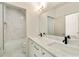Bright bathroom features double sinks, marble countertops, and tiled shower-tub combination at 3006 Skyland Ne Dr, Brookhaven, GA 30319