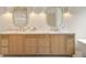 Bathroom vanity with double sinks, marble countertops, gold fixtures and stylish lighting at 3006 Skyland Ne Dr, Brookhaven, GA 30319