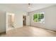Bright bedroom with a large window, light wood floors, and ensuite bathroom at 3006 Skyland Ne Dr, Brookhaven, GA 30319