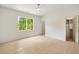 Bright bedroom with a large window, light wood floors, and a ceiling fan at 3006 Skyland Ne Dr, Brookhaven, GA 30319