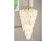 A luxurious chandelier cascades near the staircase, featuring intricate leaf-like details, and gold colored accents at 3006 Skyland Ne Dr, Brookhaven, GA 30319