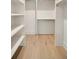 Walk-in closet with shelves and chrome bars for storage at 3006 Skyland Ne Dr, Brookhaven, GA 30319