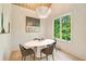 Bright dining area features a contemporary oval table, stylish chairs, modern lighting fixture and a window with verdant outdoor view at 3006 Skyland Ne Dr, Brookhaven, GA 30319