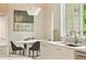 The dining area has a modern oval table and chairs, marble countertops and sink area and a large window with green views at 3006 Skyland Ne Dr, Brookhaven, GA 30319
