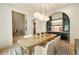 Elegant dining room with designer lighting, built-in cabinetry, and a woven dining table, perfect for entertaining at 3006 Skyland Ne Dr, Brookhaven, GA 30319