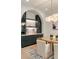 Dining area featuring custom built-in cabinets with glass shelving, a beverage fridge, and designer lighting at 3006 Skyland Ne Dr, Brookhaven, GA 30319