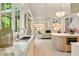 The bright kitchen offers marble counters, stainless appliances, an island, and connects seamlessly with the adjacent living room at 3006 Skyland Ne Dr, Brookhaven, GA 30319