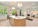 The spacious gourmet kitchen features a central island with marble countertop, white cabinets, and an open view to the living area at 3006 Skyland Ne Dr, Brookhaven, GA 30319
