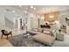Open-concept living room with hardwood floors, modern lighting, and staircase at 3006 Skyland Ne Dr, Brookhaven, GA 30319