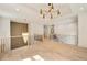 Open loft area with light hardwood floors, contemporary lighting and railing overlooking a staircase and living space below at 3006 Skyland Ne Dr, Brookhaven, GA 30319