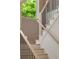 Modern staircase with wood and black metal railings ascending, with natural light from a window showcasing the design at 3006 Skyland Ne Dr, Brookhaven, GA 30319