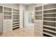 Custom walk-in closet featuring built-in shelving and drawers for optimal storage at 3006 Skyland Ne Dr, Brookhaven, GA 30319