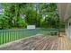 Exterior shot of a spacious wooden back deck overlooking a lush, green backyard at 34 Duke Dr, Lawrenceville, GA 30046