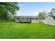 Spacious backyard with lush lawn, featuring a deck, storage shed, and ample green space at 34 Duke Dr, Lawrenceville, GA 30046
