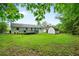 Wide backyard featuring lush green grass and a spacious deck for outdoor enjoyment at 34 Duke Dr, Lawrenceville, GA 30046