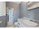 Bathroom featuring blue patterned wallpaper, a mirror and a vanity sink at 34 Duke Dr, Lawrenceville, GA 30046