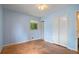 Empty bedroom featuring blue walls, a window and a closet at 34 Duke Dr, Lawrenceville, GA 30046