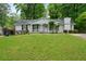 Charming single-story home with a lush green lawn and a welcoming front porch at 34 Duke Dr, Lawrenceville, GA 30046