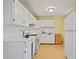 Practical kitchen featuring white cabinetry, appliances, and ample countertop space at 34 Duke Dr, Lawrenceville, GA 30046