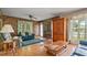 Cozy living room with wood paneling, hardwood floors, and a comfortable seating area at 34 Duke Dr, Lawrenceville, GA 30046