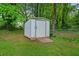 Exterior shot of a storage shed in the backyard with a wood ramp at 34 Duke Dr, Lawrenceville, GA 30046