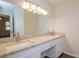 Bathroom featuring a double vanity with granite countertops, modern fixtures, and spacious mirrors at 574 Oak Grove Rd, Temple, GA 30179