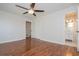 This bedroom features a ceiling fan, hardwood floors, a closet and an attached bathroom at 574 Oak Grove Rd, Temple, GA 30179