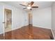 This bedroom features a ceiling fan, closet, and an attached bathroom with tile floors at 574 Oak Grove Rd, Temple, GA 30179