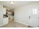 Bright entryway with a white door and an adjacent view of the kitchen featuring modern appliances at 574 Oak Grove Rd, Temple, GA 30179