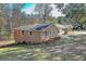 A well-maintained brick home is shown with a manicured lawn at 574 Oak Grove Rd, Temple, GA 30179