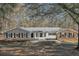 Charming ranch-style home with brick facade, black shutters, and a welcoming entrance at 574 Oak Grove Rd, Temple, GA 30179
