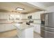 Well-lit kitchen with stainless steel appliances, white cabinets, and a granite island at 574 Oak Grove Rd, Temple, GA 30179
