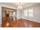 Open living room area with hardwood floors, fireplace and a large window for natural lighting at 574 Oak Grove Rd, Temple, GA 30179