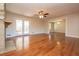 Spacious living room featuring hardwood floors, a ceiling fan, and stone fireplace at 574 Oak Grove Rd, Temple, GA 30179