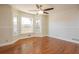 Cozy living room area with hardwood floors, wainscoting, and a bright bay window at 574 Oak Grove Rd, Temple, GA 30179