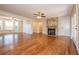 Spacious living room with hardwood floors, a brick fireplace, and french doors to a screened in porch at 574 Oak Grove Rd, Temple, GA 30179