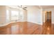 Bright living room with hardwood floors, large windows, and a ceiling fan at 574 Oak Grove Rd, Temple, GA 30179