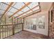 Enclosed porch featuring a wood-plank floor, bright lighting, and clear views of the surrounding nature preserve at 574 Oak Grove Rd, Temple, GA 30179