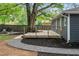 Charming backyard featuring a wooden deck, fire pit, and gravel pathways, ideal for outdoor relaxation at 957 Sharon Se Cir, Smyrna, GA 30080